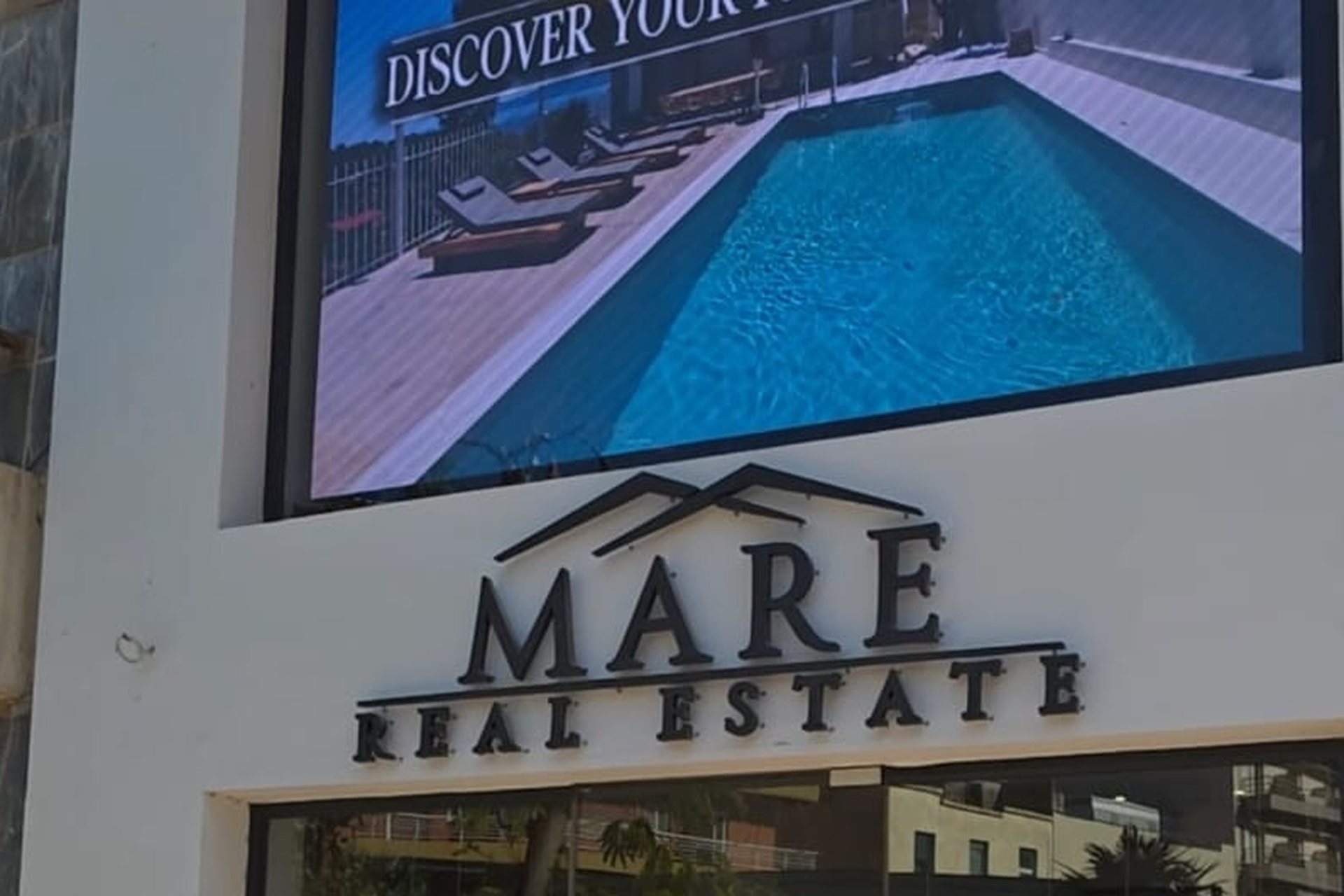 The MARE Real Estate office on the main square of Loutraki, Greece